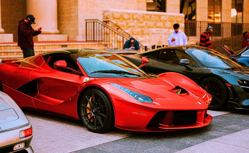 Red Ferrari by other luxury supercars.