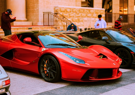 Red Ferrari by other luxury supercars.