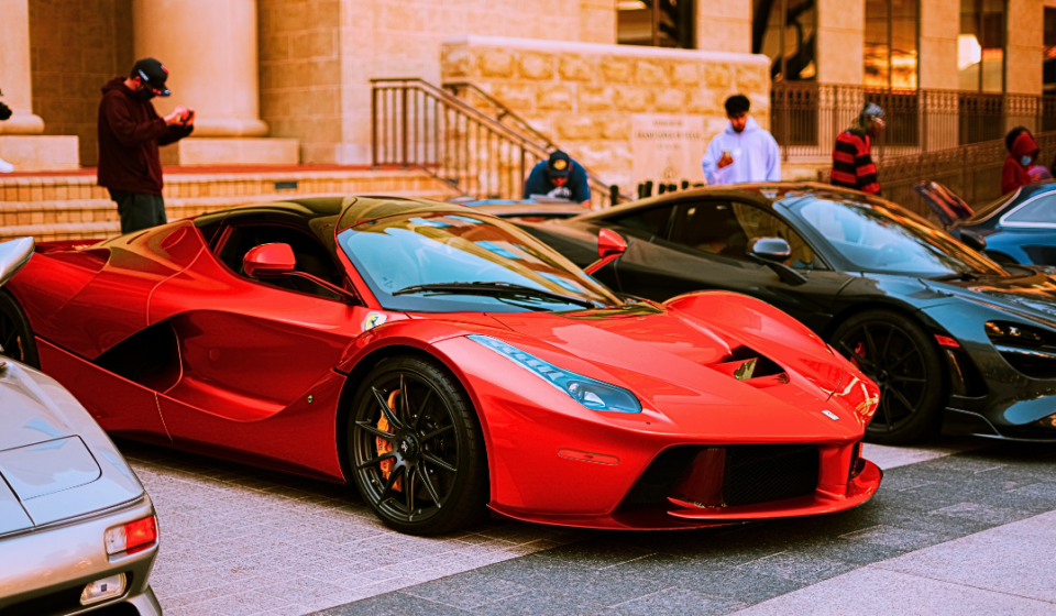 Red Ferrari by other luxury supercars.