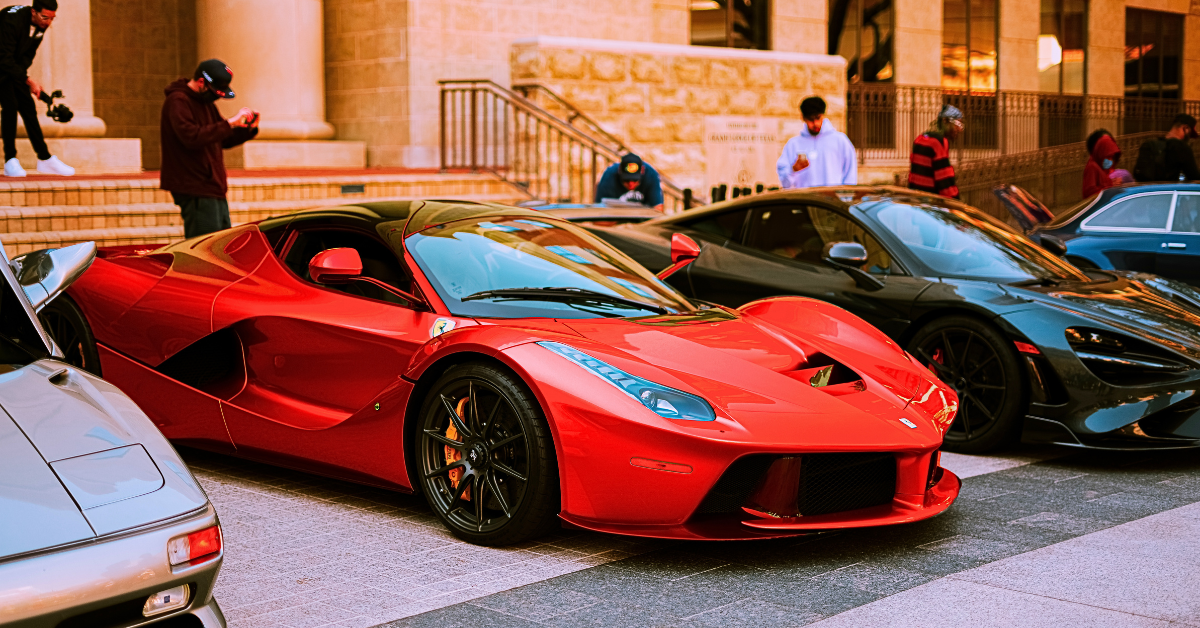 Red Ferrari by other luxury supercars.